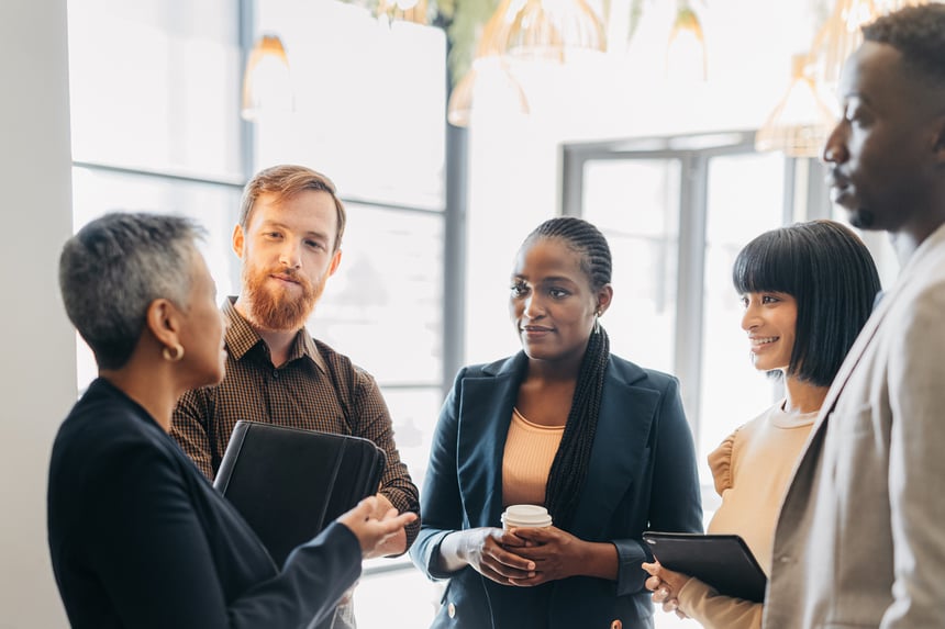Female-leader,-manager-or-CEO-in-a-meeting-with-her-corporate-team-for-planning,-strategy-and-learning.-Leadership,-management-and-mentorship-with-a-woman-boss-and-her-staff-talking-in-the-office-1425880087_1258x838 (1)