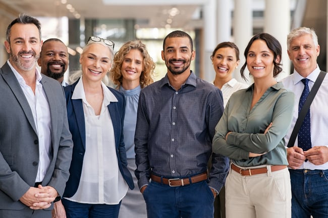 A smiling team standing together in their office