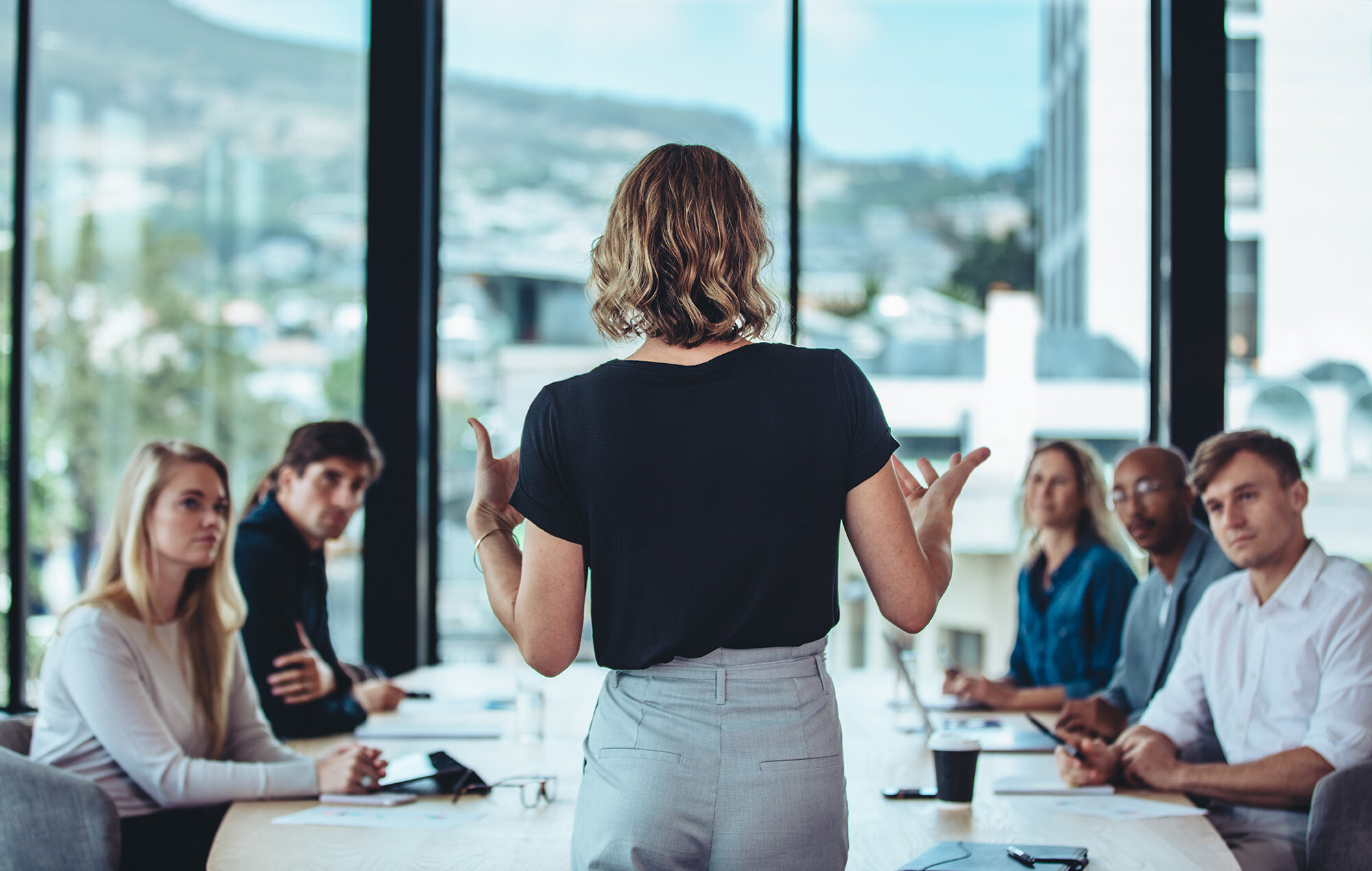 A leader presenting to her team in a meeting room